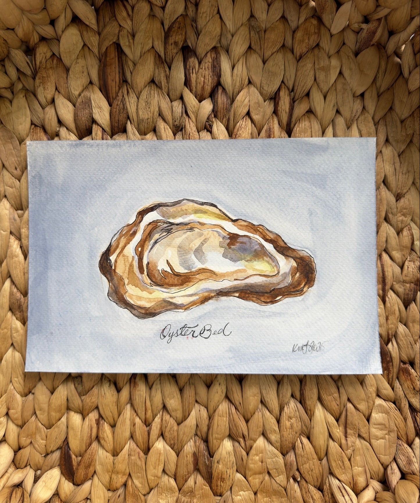 Watercolor painting of an oyster shell on a textured woven surface