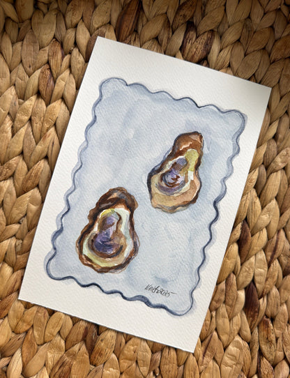 Card with a drawing of two oysters on a textured woven surface
